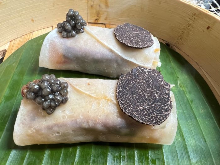 The duck wraps with caviar and truffle on top The duck wraps with caviar and truffle on top