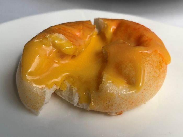 The duck yolk custard oozing out of the bun The duck yolk custard oozing out of the bun