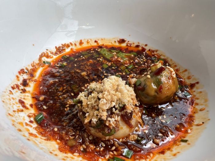 Won ton with garlic, chilli oil and soy poached yolk Won ton with garlic, chilli oil and soy poached yolk