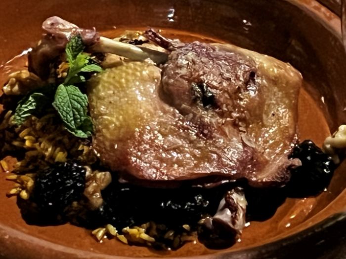 Main course tagine of oven roasted confit of duck leg