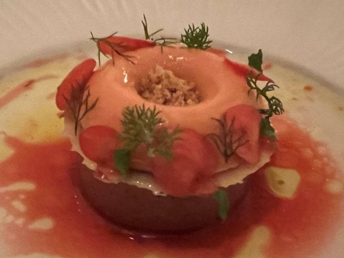 Tasting menu dessert of plum, custard, and apple blossom