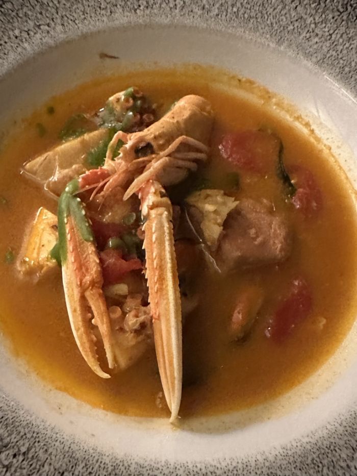First course of fish soup with saffron pistils