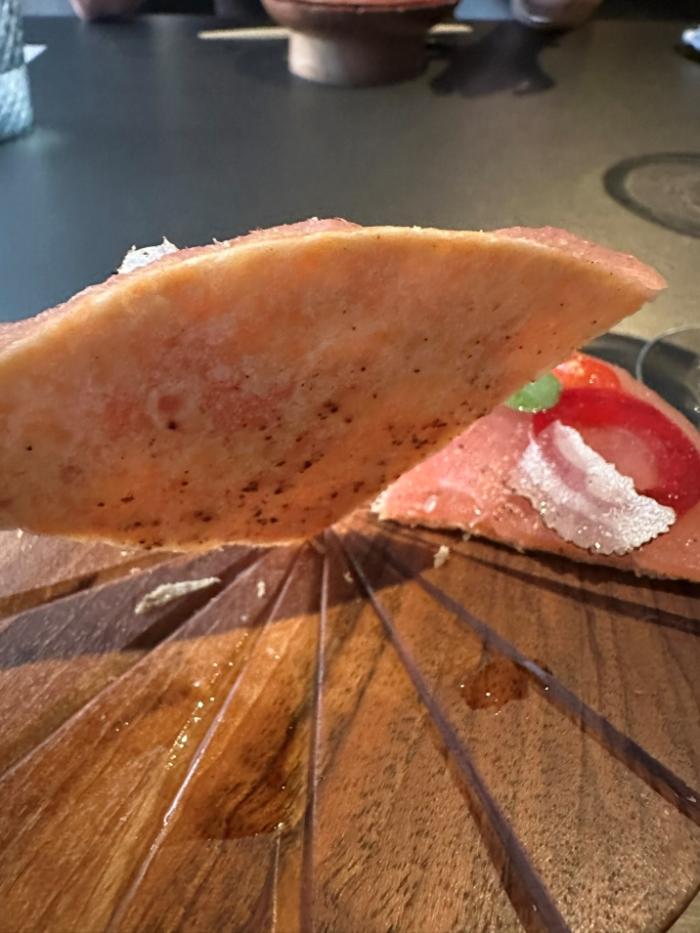 The crisp base of the AB Tuna Pizza The crisp base of the AB Tuna Pizza