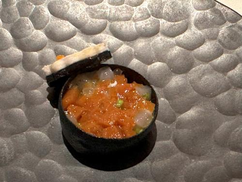 Appetizer of Shetland squid with lid removed